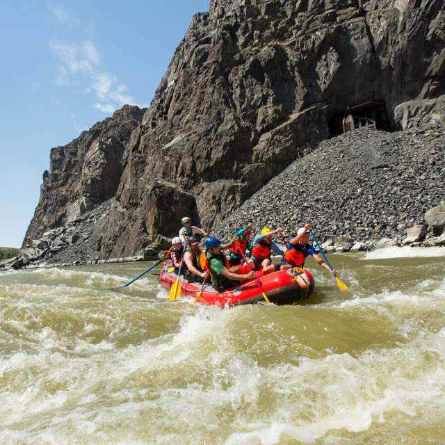 Group of people rafting through whitewater rapids on a river in Fremont County, near Thermopolis, Wyoming.