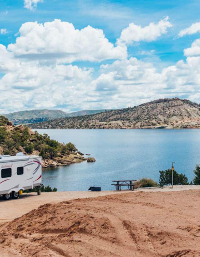 Serene waters of Alcova Reservoir surrounded by rocky cliffs in Natrona County, Wyoming.